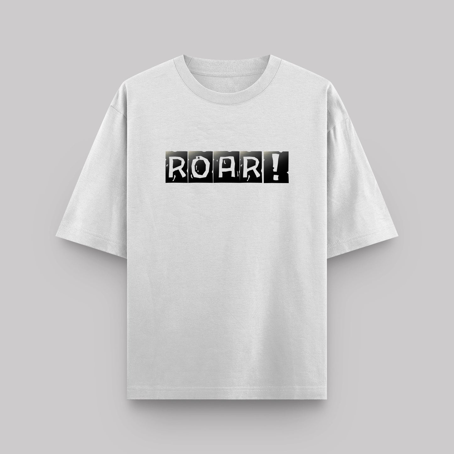 White t-shirt with 'ROAR!' print on a gray background