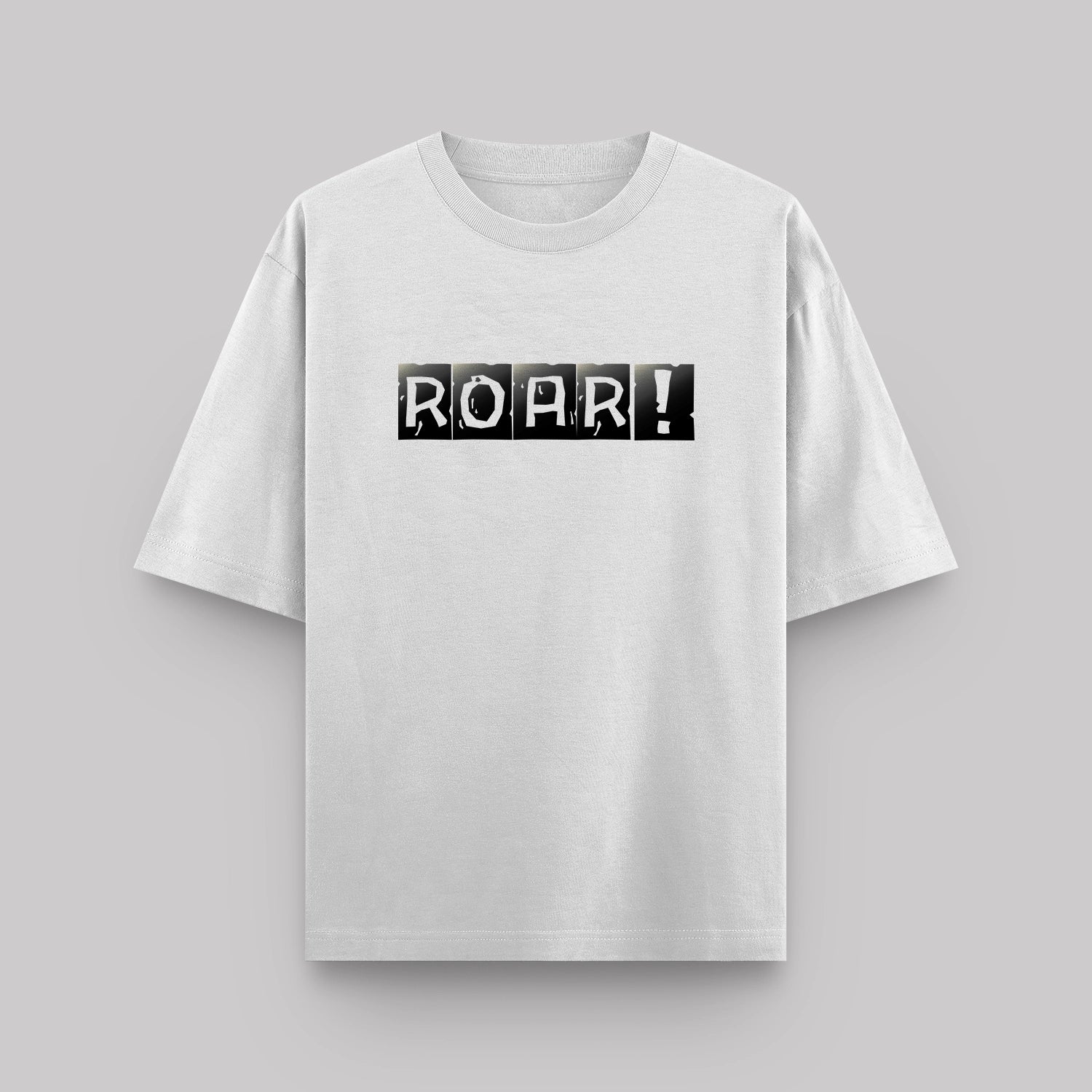 White t-shirt with 'ROAR!' print on a gray background