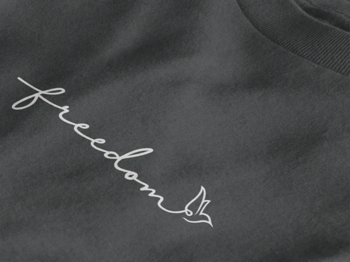 Close-up of a Graphite t-shirt featuring a white script word 'freedom' and a small bird outline on the chest.