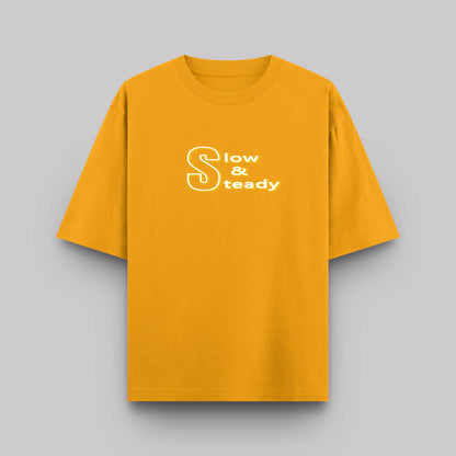 Yellow t-shirt with 'Slow & Steady' text on a gray background