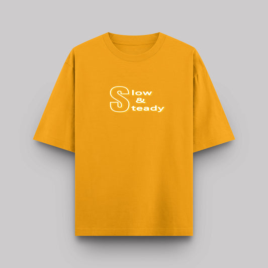 Yellow t-shirt with 'Slow & Steady' text on a gray background
