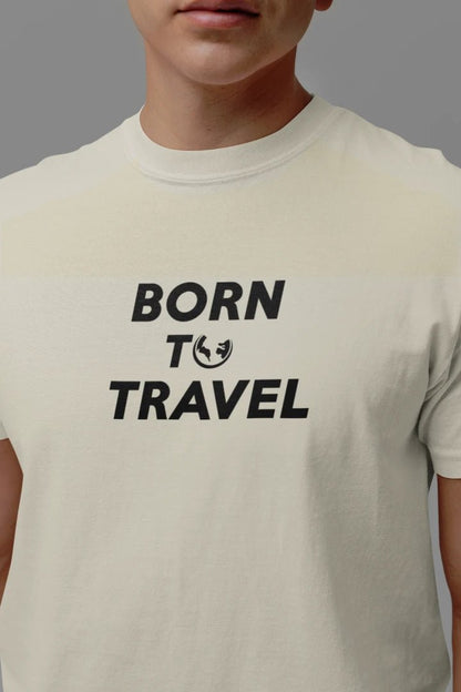 A close-up of a person wearing a Off White t-shirt with the black printed text 'BORN TO TRAVEL' and a small globe icon on the chest, set against a solid gray background.